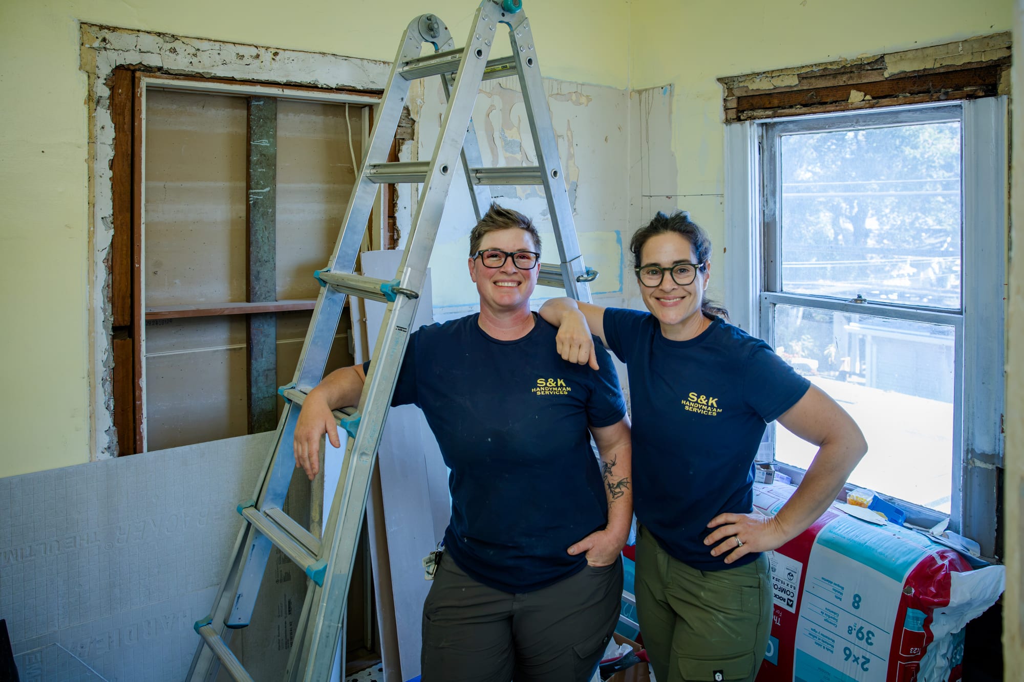 SJ and Lisa smiling on an active remodel job site in Santa Rosa